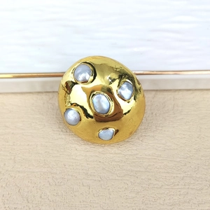 Detail of irregular gold-plated ring set with five grey natural freshwater pearls