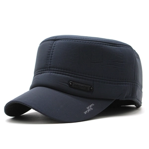 Detail view of navy quilted flat cap featuring ear flaps and SPORTS print on brim