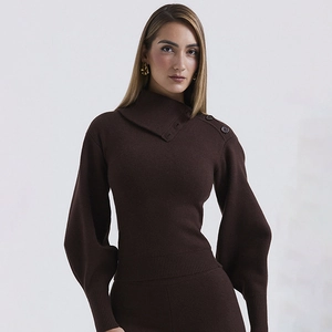 Detail of dark brown knit set with asymmetric neckline, buttons, and soft fabric texture