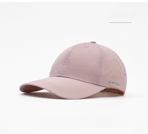 Detail of pink quick-dry golf cap with laser-cut ventilation and GLWR GOLF lettering