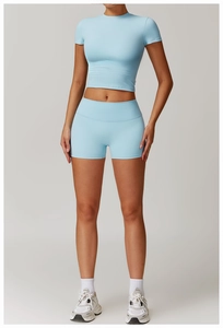 Detailed view of light blue high-waist yoga set with slim fit crop top and sports shorts