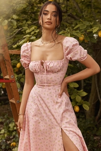 Close-up of pink floral summer dress featuring puff sleeves and a side slit design