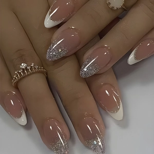 Detail of almond-shaped press on nails with French tips and silver gradient glitter