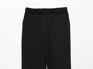Close-up detail of the elastic high waist design on black flare trousers for women