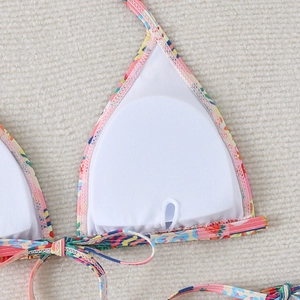 Detail of bikini top interior showing breathable white mesh lining and removable pads