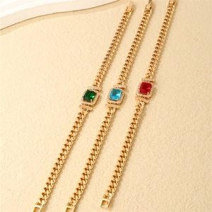 Golden Cuban chain bracelets with emerald, ruby, and sapphire zirconia rectangular stones