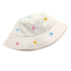 Detailed close-up of floral embroidery on a cream cotton bucket sun hat for women