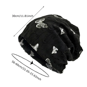 Black knit slouchy beanie with butterfly prints and distressed details, 30cm height