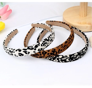 Three vintage leopard print padded headbands in white, brown, and black velvet texture