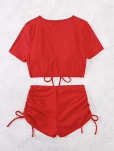 Detail of red high-waisted bikini bottoms with adjustable side drawstring ruched design
