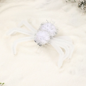 Macro shot of white plush spider hair clip with furry texture for Halloween parties