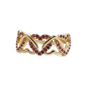 Detailed macro view of continuous golden heart patterns with red gemstone pavé settings