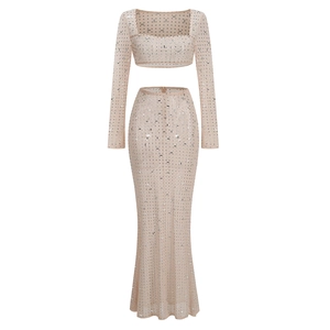 Sparkly two-piece evening set featuring long sleeve crop top and matching maxi skirt