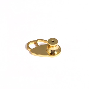 Macro view of polished golden metal earring lifter support with a smooth glossy finish