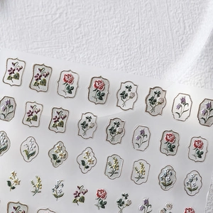 Vintage floral 5D nail art stickers with embossed rose and lily patterns in retro frames