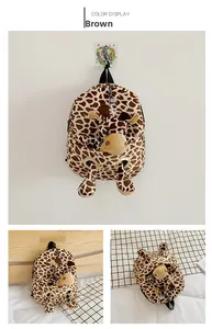 Detail view of brown giraffe pattern backpack with a 3D plush animal toy on the front