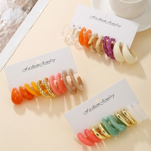 Detail of colorful acrylic C-shape hoop earrings set on fashion jewelry cards