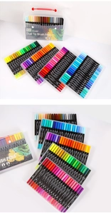 Detailed view of 100-color dual tip brush pens in a transparent portable carrying case