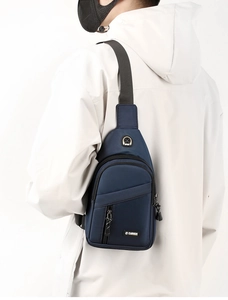 Detail of waterproof oxford chest bag in dark blue with headphone port and multiple zip pockets