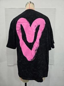Detail of pink graffiti heart print on vintage washed black oversized t-shirt