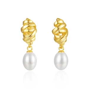 Detail of twisted gold metal spiral design with a lustrous teardrop pearl on the earring