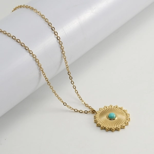 18K gold plated stainless steel turquoise sunburst pendant necklace on a white pedestal