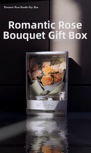 Macro shot of orange soap rose bouquet with lighting reflections and elegant gift box
