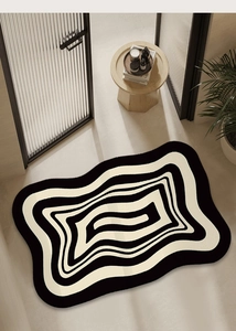 Irregular wavy carpet with black and beige geometric stripes in a modern home setting