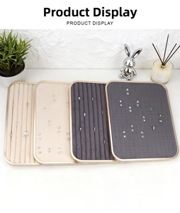 Detailed view of rectangular velvet jewelry trays with gold metal frames for earrings