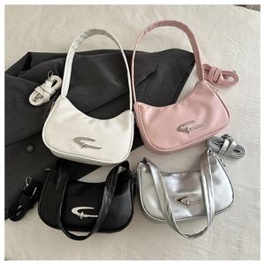 Flat lay of vintage half-moon underarm bags in four colors with star metal logos
