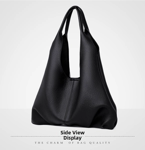 Close-up of side view showing soft black litchi grain leather texture on tote bag