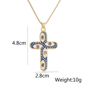 Detailed view of 18K gold plated cross pendant with blue enamel eyes and dimensions