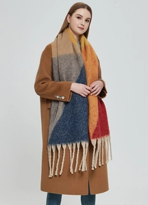 Detail of a thick oversized scarf with geometric color blocks and coarse fringes