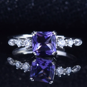 Macro view of square purple amethyst ring with side diamonds and vintage beaded detailing