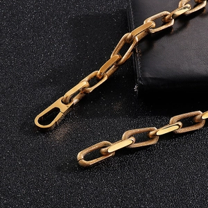 Close-up of golden 10mm titanium steel chain with spring clasp on black background
