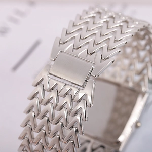 Detail of silver steel watch strap with unique V-shaped links and secure clasp