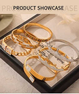 Macro shot of assorted gold and silver luxury bracelets with colorful stones on jewelry tray