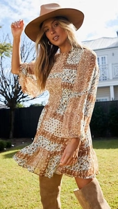 Detail showing the floral print pattern and ruffled hem of the bohemian mini dress