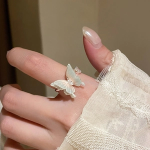 Detail of elegant silver butterfly ring with mother-of-pearl wings and crystal accents