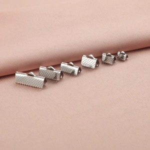 Various sizes of silver stainless steel ribbon crimp ends with textured surface