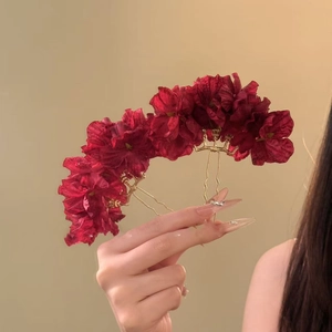 Close-up of handmade burgundy silk flower hairpins with gold-plated wavy pins for women