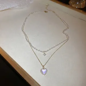 Double-layer zircon pearl heart necklace with purple stone pendant on display tray