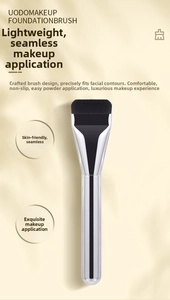 Flat top foundation brush with dense black bristles and shiny silver metal handle