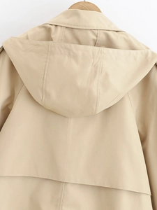 Close-up of the hood and back seam detail on a khaki hooded windbreaker jacket