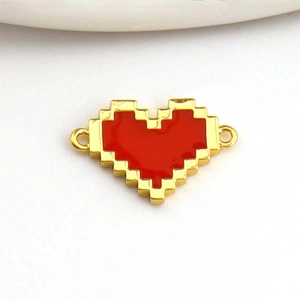 Macro view of pixelated red heart pendant with gold plating and enamel inlay details