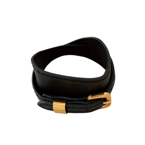 Minimalist black faux leather choker with gold metal buckle and stitching detail on white
