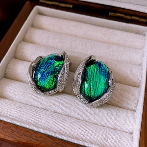 Detail of vintage earring with turquoise resin stone and diamond-set silver frame