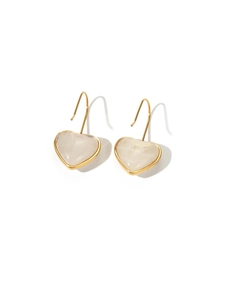 Close-up of heart-shaped gold earrings with white marble texture and elegant hooks