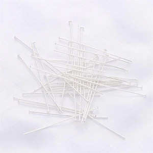 Macro shot of silver-plated T-pins and flat head pins for DIY jewelry making