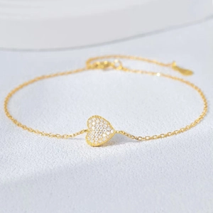 Close-up of gold-plated heart bracelet with zircon pavé setting and delicate O-chain